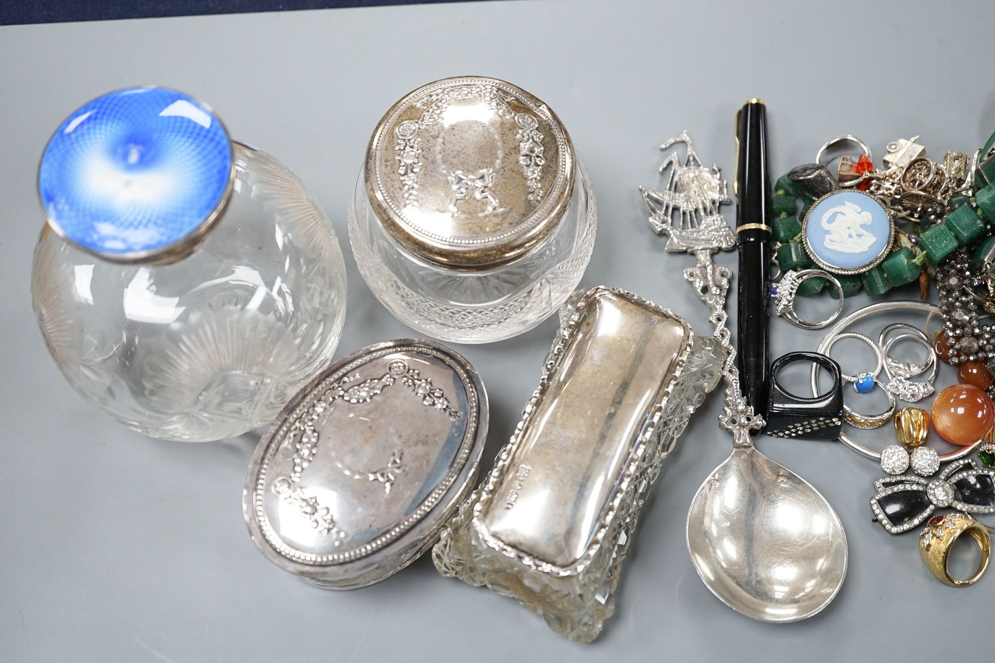 A silver and enamel mounted glass scent bottle(a.f.), three silver mounted glass toilet jars and aassorted jewellery including silver.